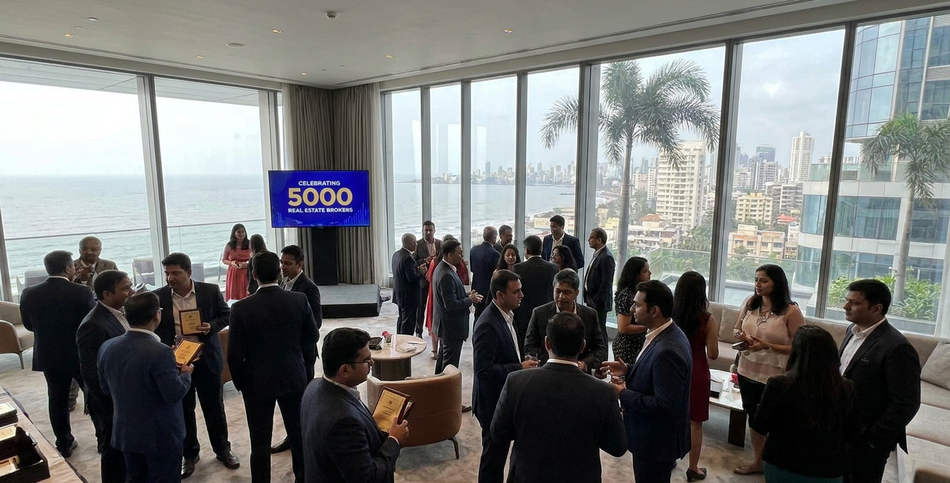 group of professionals in suits networking at a coastal rooftop lounge with floor to ceiling windows and an ocean view