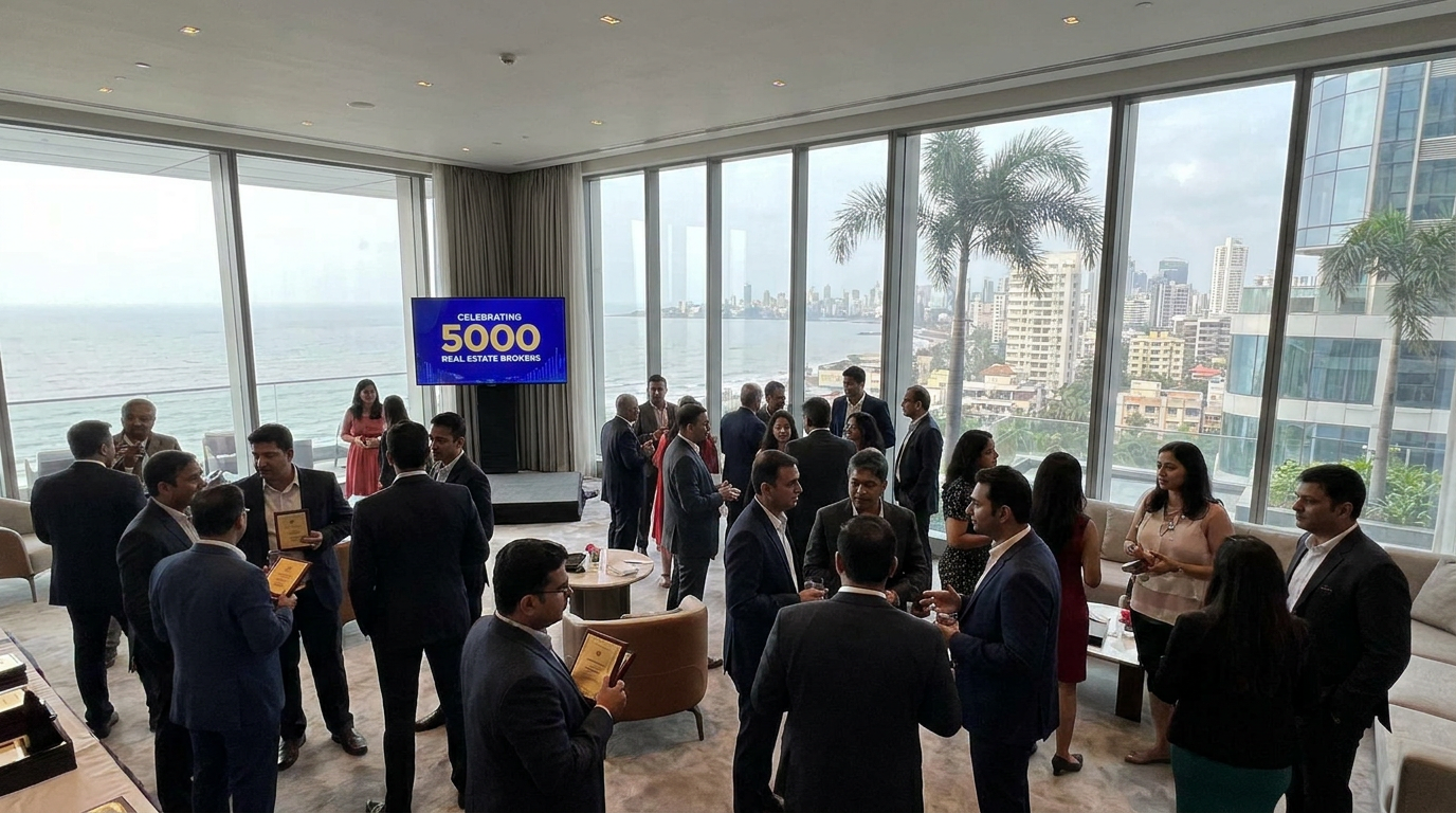 Group of professionals in suits networking at a coastal rooftop lounge with floor-to-ceiling windows and an ocean view.