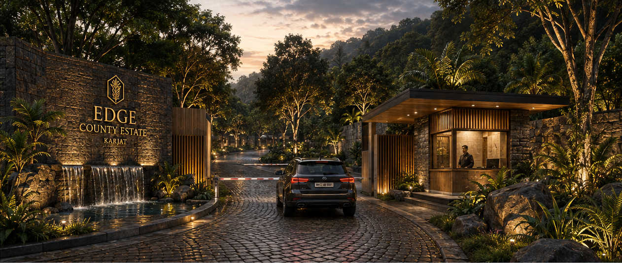 entrance to edge county estate karjat with a lit sign stone wall cobblestone driveway and security pavilion at dusk lush landscaping surrounds a gated entry